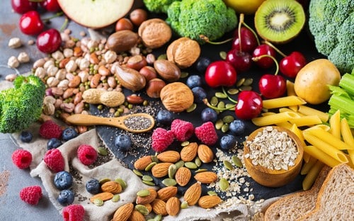 Fruits, vegetables, nuts, and grains scattered within each other