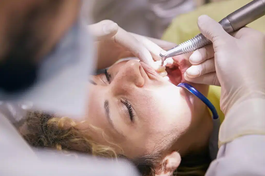 a young woman getting her Teeth Cleaned